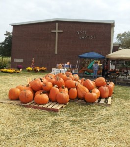 pumpkins piled in front of the church